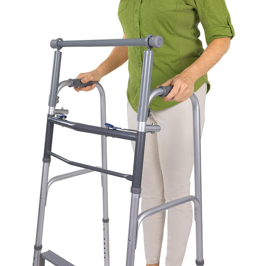 Person using a silver walker on a white background
