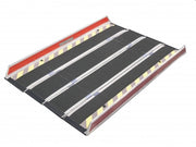 Black metal ramp with red top and yellow reflective stripes on a white background