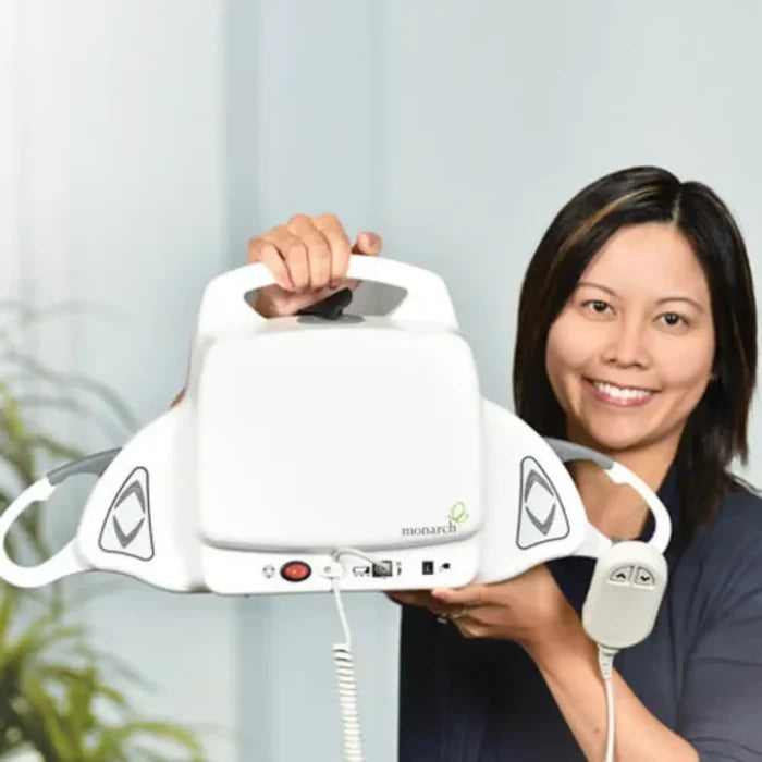 Woman holding a white Monarch device against a light background