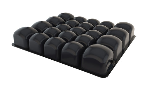 Black foam roller with multiple cylindrical segments on a white background