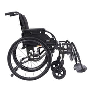 A black manual wheelchair with a folding frame, large rear wheels, small front casters, and a footrest, shown from a side angle on a plain white background.