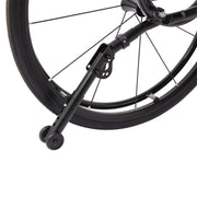 Close-up of a black bicycle wheel with a rear wheel stand attached to the hub, shown against a plain white background.