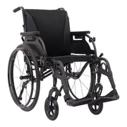A black manual wheelchair with a padded seat and backrest, shown from a three-quarter angle against a plain white background.