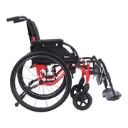 A compact manual wheelchair with a black seat and wheels, accented by a bright red frame, shown from a side angle on a white background.