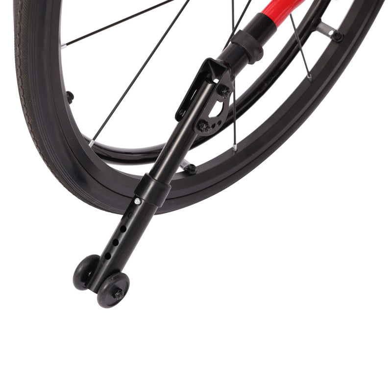 Close-up of a bicycle wheel with a black metal rear rack or support stand attached near the hub, on a white background.