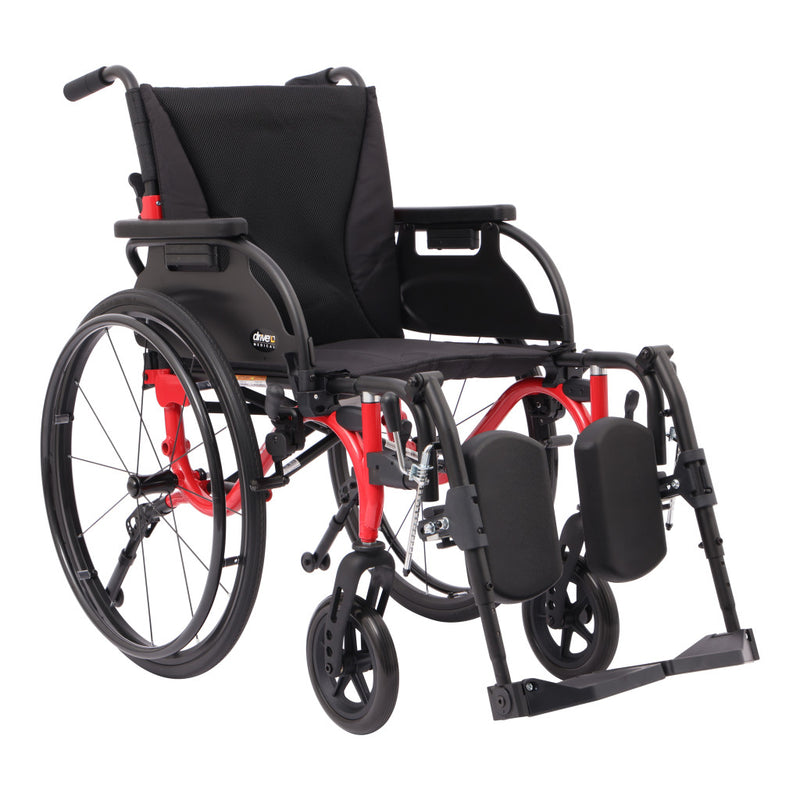 A manual wheelchair with a black fabric seat and backrest, black wheels and armrests, and a red metal frame, shown on a plain white background.