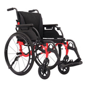 A manual wheelchair with a black fabric seat and backrest, black wheels and armrests, and a bright red metal frame, shown on a solid white background.