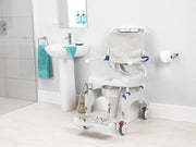 Bathroom with a commode chair and sink