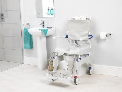 Bathroom with a commode chair and sink
