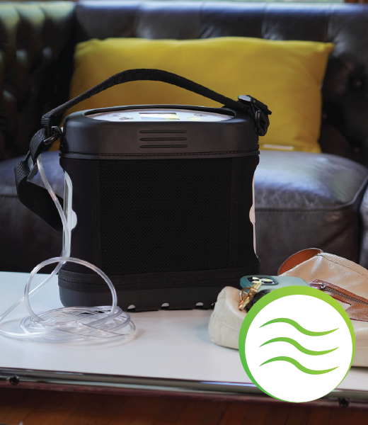 Black portable device with a strap on a surface, with a green icon featuring wavy lines in the corner.