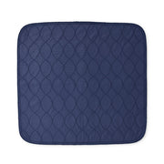 A navy blue quilted mat with a repeating circular stitched pattern, shown flat against a solid white background.