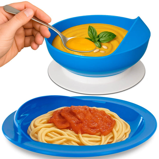 Blue bowl with yellow soup and basil leaves, and blue plate with spaghetti and red sauce on a white background.