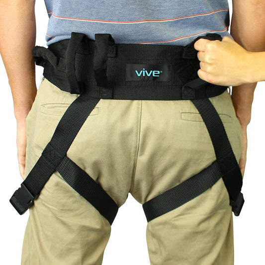Person wearing a black harness with 'vive' branding on a white background