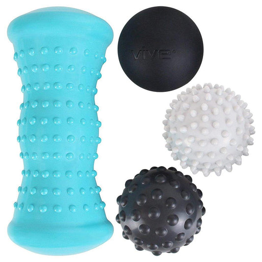 Set of massage balls and roller with textured surfaces on a white background