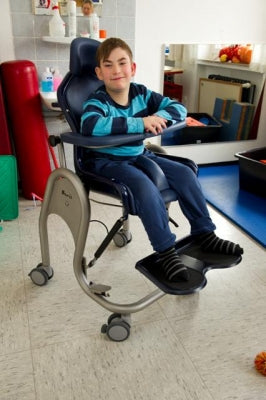 Child using a specialized chair in a clinical setting