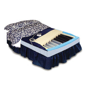 An orthopedic mattress shown with its dark navy blue skirt and patterned bedding removed to reveal the internal support system, including a beige pillow insert and black and gray foam layers, on a white background.