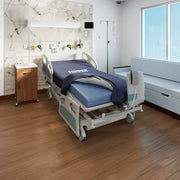 Hospital room with a patient bed and medical equipment.