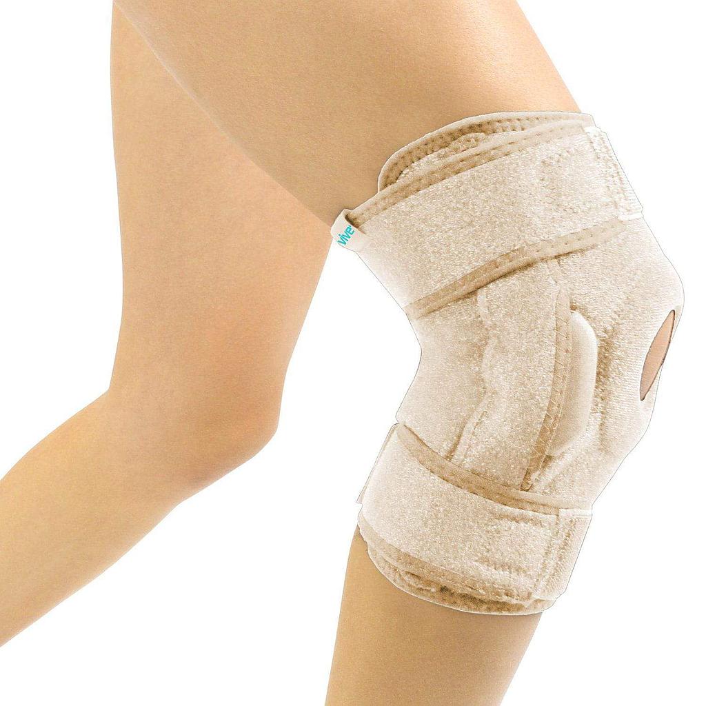 Beige knee brace on a person's knee against a white background