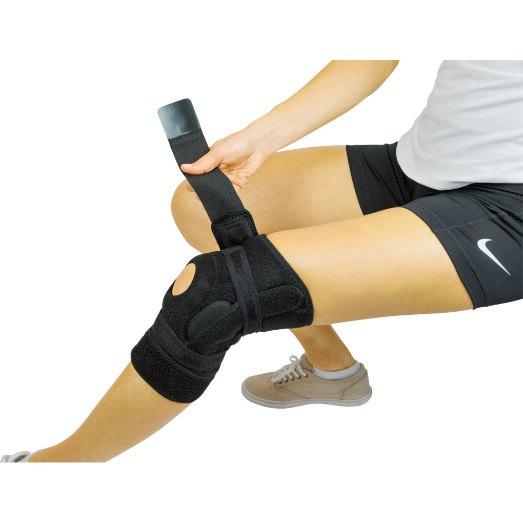 Person wearing a black knee brace on a white background