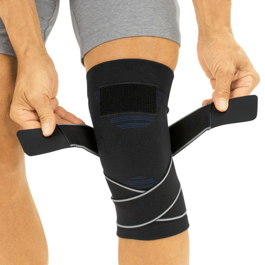 Person wearing a black knee brace on a white background