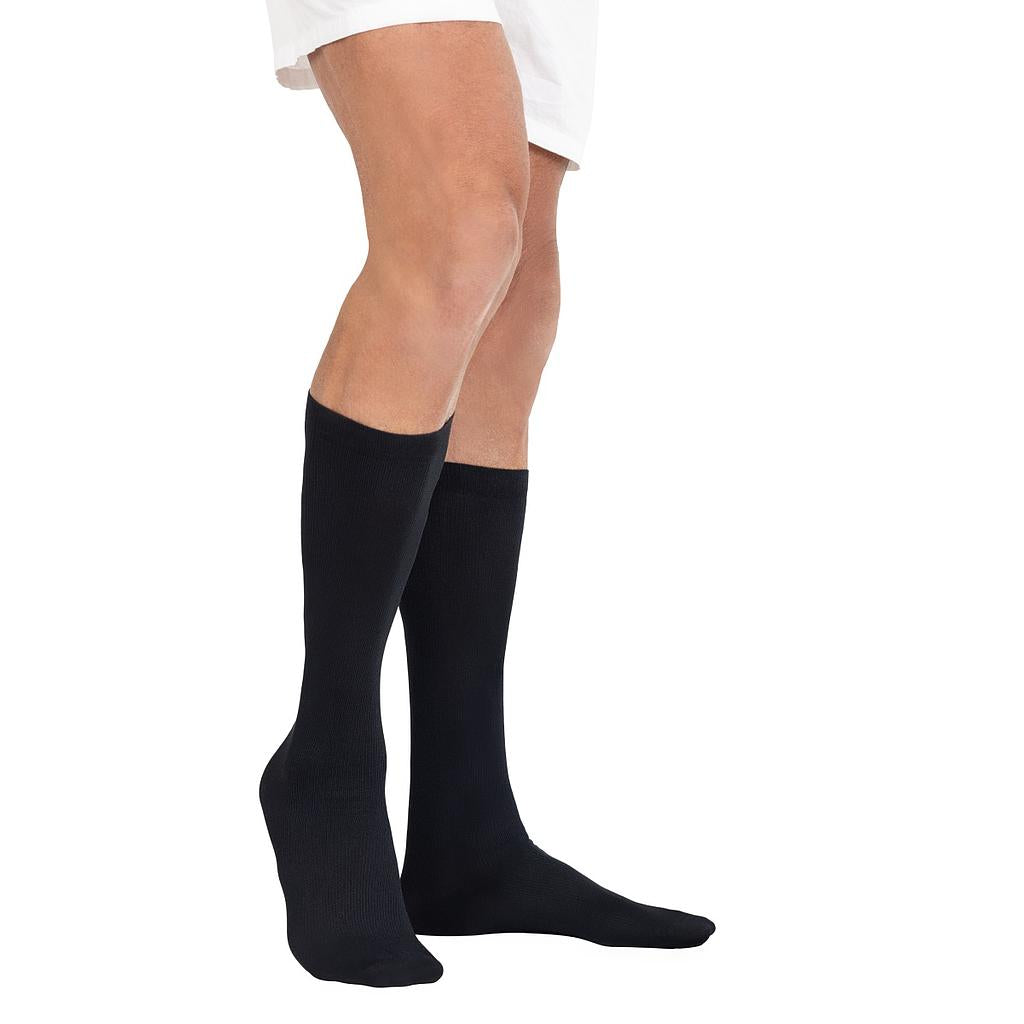 Black knee-high socks worn by a person on a white background