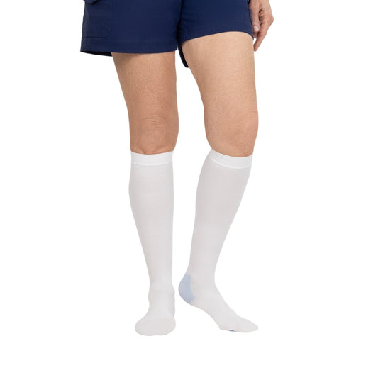 White knee-high socks worn with navy shorts on a white background
