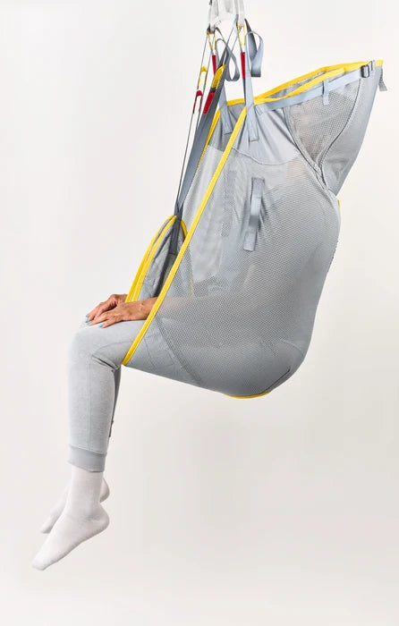 Person sitting in a gray and yellow hammock chair on a white background