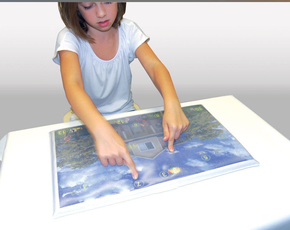 Child interacting with a large interactive chart on a table.