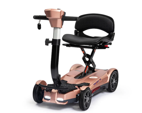 Rose gold mobility scooter with a black seat on a white background