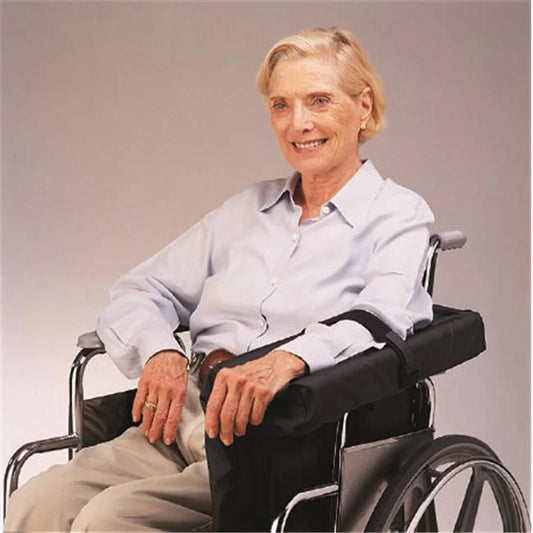 Woman in a wheelchair wearing a white shirt against a plain background