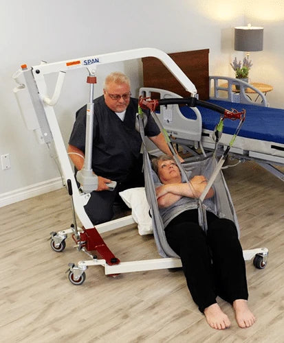 caregiver lifting a senior with the lift
