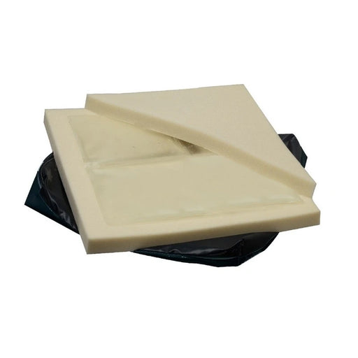 Two square off-white foam inserts stacked on top of a black plastic bag, photographed against a plain white background.