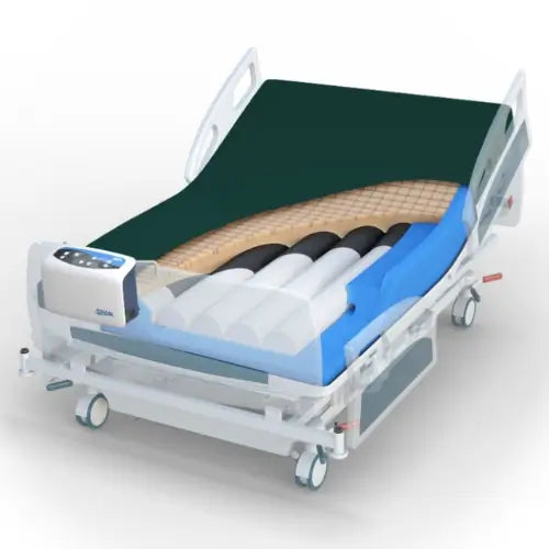 An adjustable hospital bed with a dark green backrest, blue mattress cover, and a transparent side panel showing internal airway or support tubes, on a light gray background.