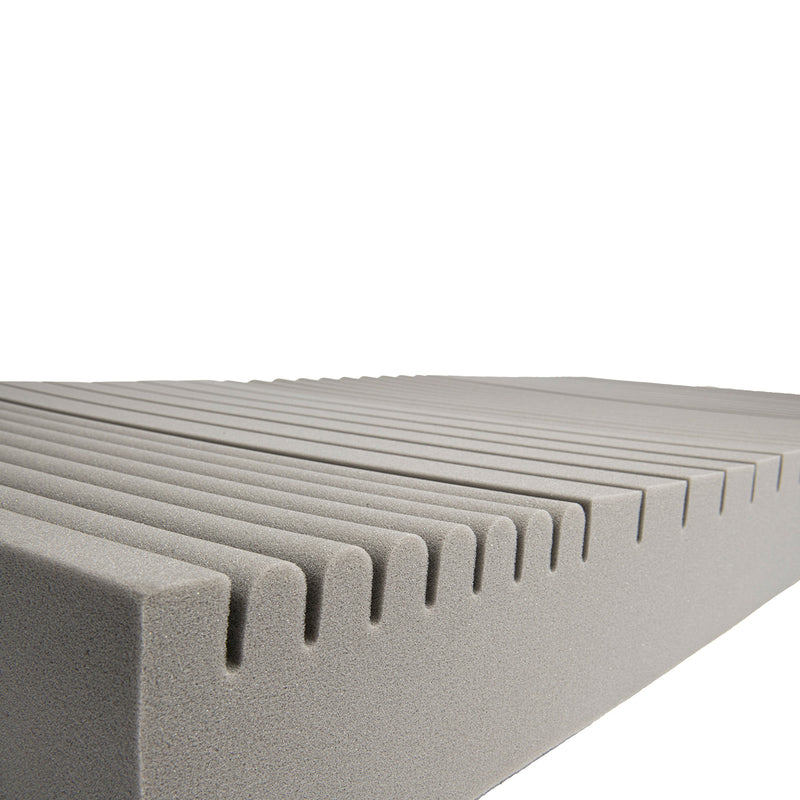 Close-up of a textured gray foam block with a white background