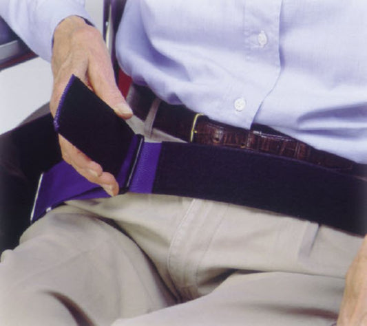 Person wearing a purple belt with a white shirt and beige pants.