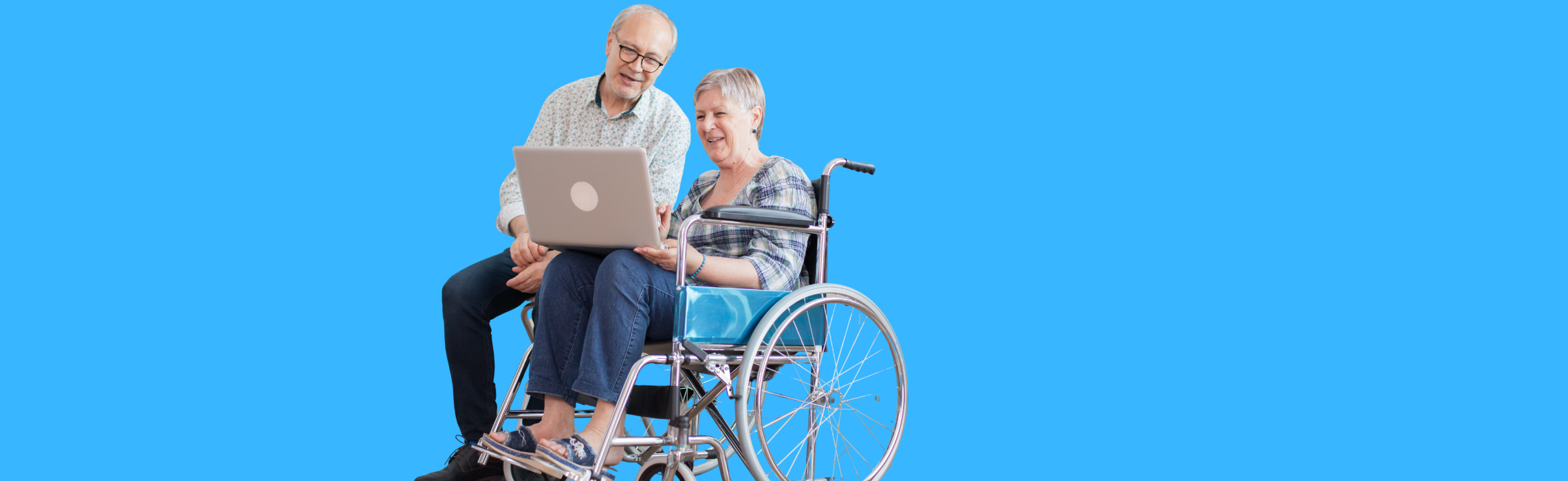 Two people, one using a laptop, sitting together on a blue background