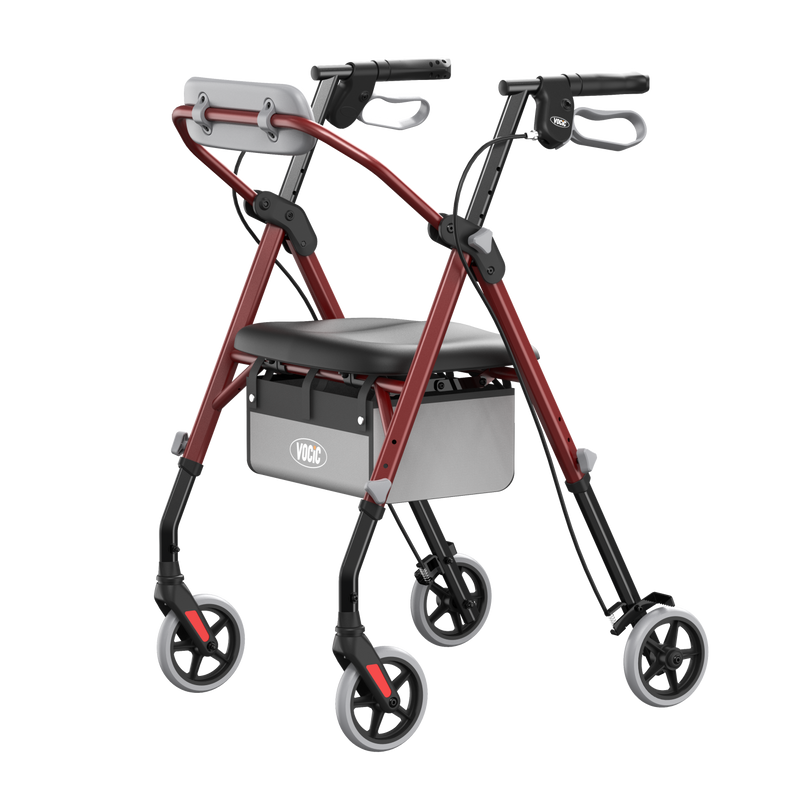 A rollator walker with a red metal frame, black seat, gray backrest, and four wheels, shown on a plain white background.