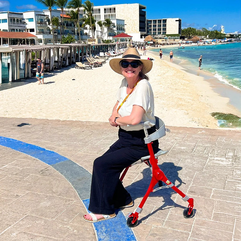 woman sitting on her rollator beachside 