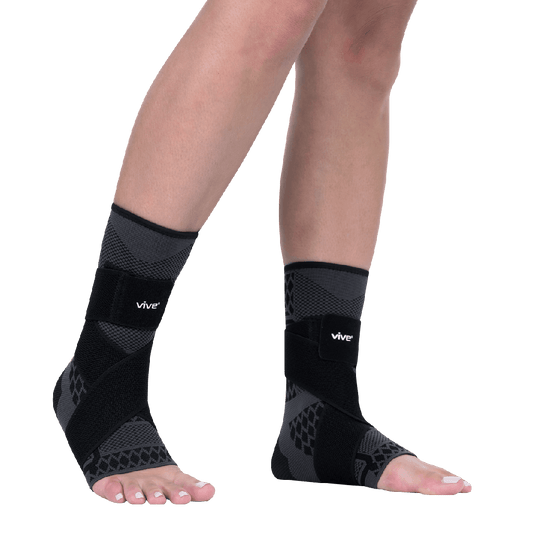 Black ankle support sleeves with 'vive' branding on a transparent background