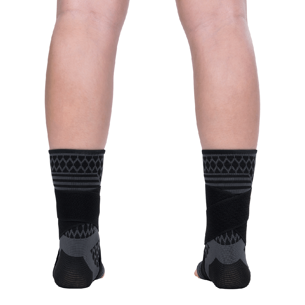 Black patterned socks worn by a person on a transparent background