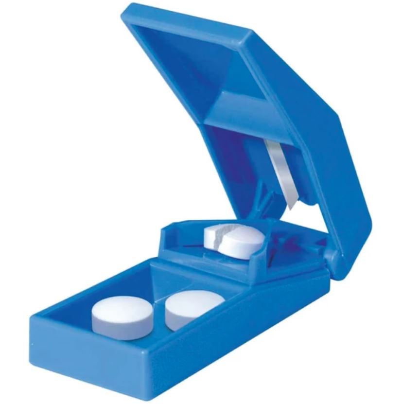 Blue pill organizer with three white pills on a white background