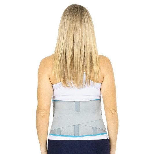 Person wearing a back brace on a white background