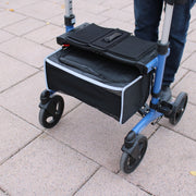 Black and blue wheeled cart with a storage bag on a paved surface