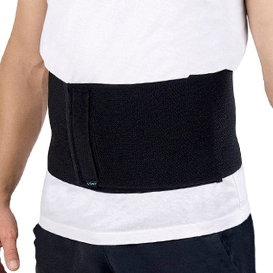 Black waist support belt worn by a person on a white background
