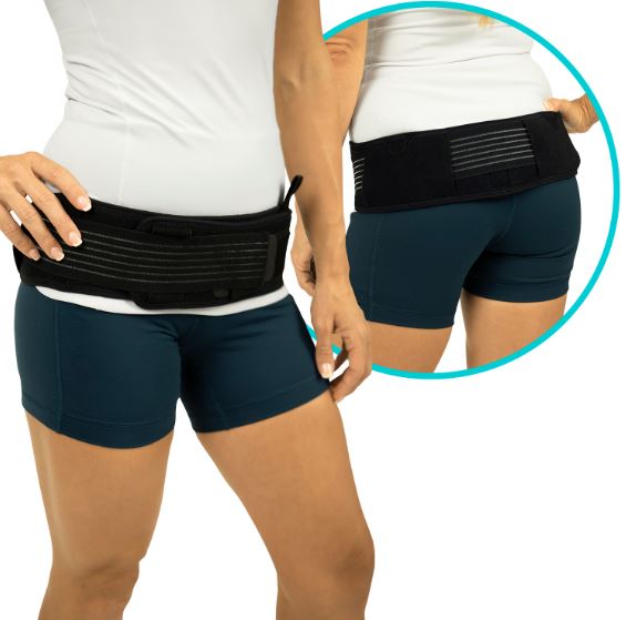 Person wearing a black waist support belt with a close-up inset.