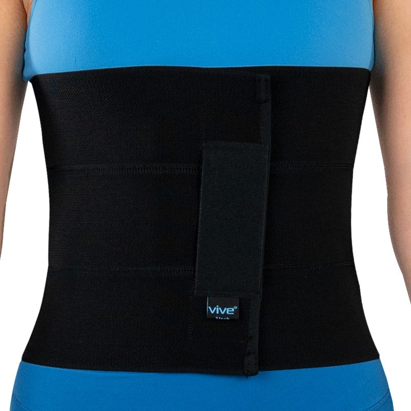 Black waist support belt with 'Vive' logo worn by a person on a white background