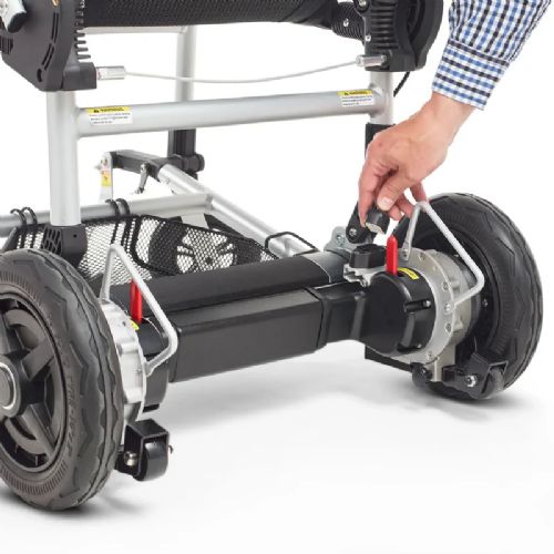 Close-up of a wheelchair's undercarriage with a hand adjusting a component on a white background
