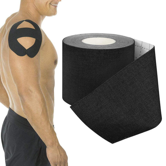 Black kinesiology tape applied to a person's shoulder with a roll of tape on a white background
