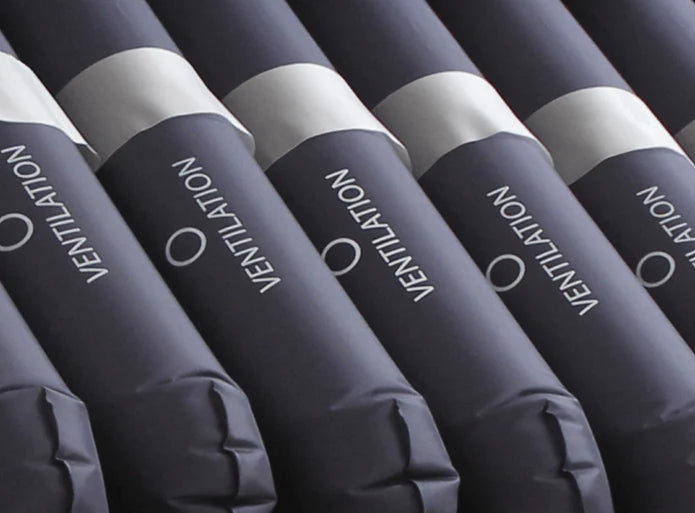 Row of blue inflatable tubes with 'Ventilation' text on a dark background