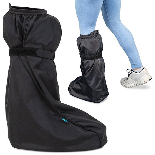 Black rain boot covers with a person wearing them on a white background